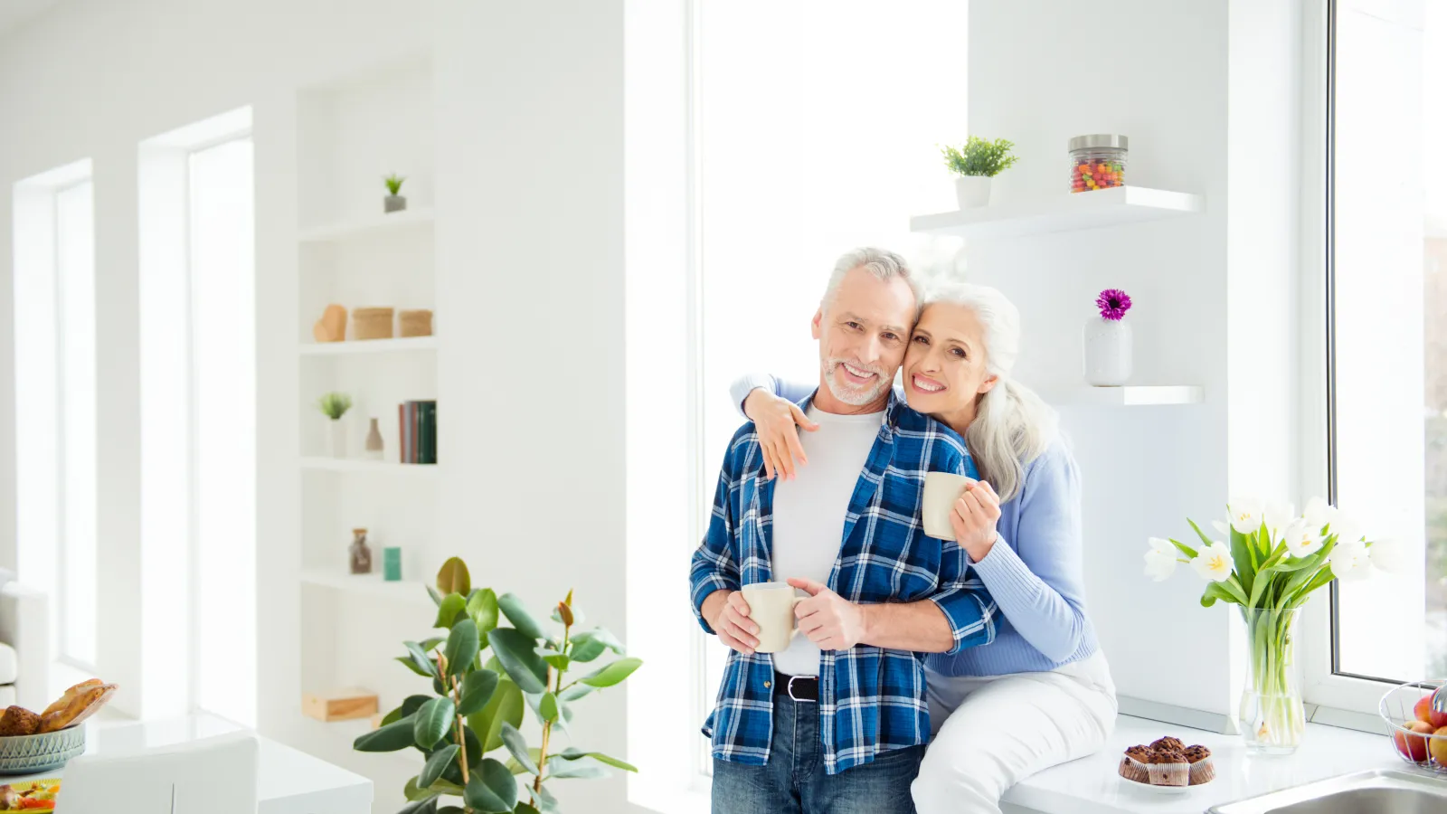 a couple in the kitchen drinking coffee