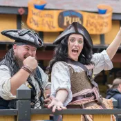 a man and woman pirates with beer