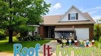 Suburban house with tree and cartoon kids graphic promoting Roof It Forward roofing program.