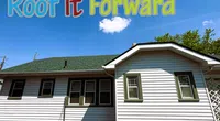 Single-story house with green roof under blue sky and Roof It Forward logo with cartoon children at top.