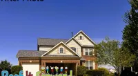 Two-story suburban house with brick and beige siding under clear blue sky, surrounded by trees and lawn