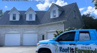 Blue and white Roof It Forward truck parked in driveway of large house with gray roof and garage doors