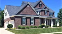 a large brick house with a new roofing system