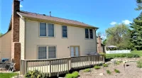 a large brick building with grass in front of a house