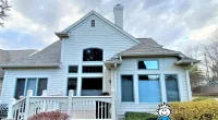a house with a lawn in front of a building
