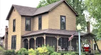 a house with bushes in front of Eudora Welty House