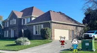 a house with a driveway and a driveway with a toy figure in front