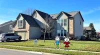 a couple of toy figures in front of a house