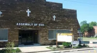 a large brick building with a sign on the side of a road