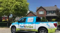 a Roof It Forward truck parked in front of a house