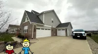 a toy on a road with a house and a car in the background