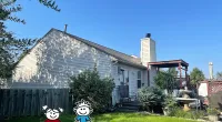 a house with a cartoon character in front of it