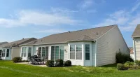 a house with a lawn and chairs