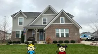 a house with a large lawn and a toy in front of it