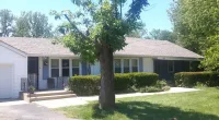 a tree in front of a customer's home