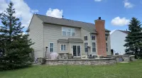 a large brick building with grass in front of a house