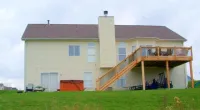 a large green field in front of a house