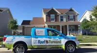 a Roof It Forward truck parked in front of a house