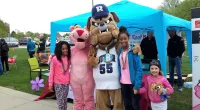 kids and mascots posing for a picture