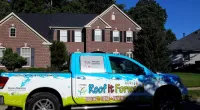 a Roof It Forward truck parked in front of a house