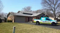 a Roof It Forward truck parked in front a customer's home