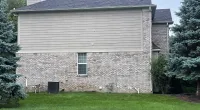 a stone building with a grass yard