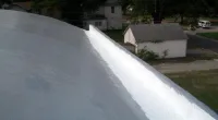 a man riding a skateboard down the side of a road