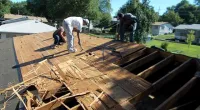 a man standing on top of a wooden ramp