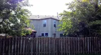 a house with a fence behind it