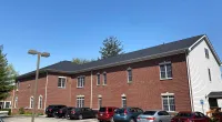a brick building with cars parked in front of it