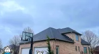 a brick house with a cartoon character in front of it