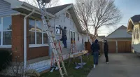 people working on the new siding