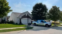 a police truck parked in front of a house