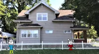 a house with a fence in front of a building