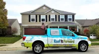 a Roof It Forward truck parked in front of a home