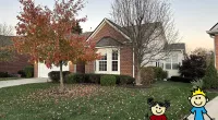 a house with a yard and a tree with a cartoon character