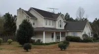 a house with trees in the front yard