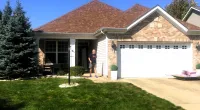 a house with a lawn and a driveway