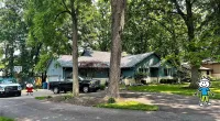 a tree in front of a house