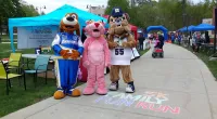 three mascots posing for a picture