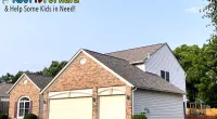 Suburban house with new roof shingles under clear sky, promoting Roof It Forward charity for kids in need.