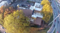 A high view of a building surrounded by trees