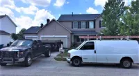 trucks parked in front of a house