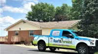 a Roof It Forward truck in front a home