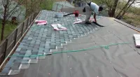 people working on a customer's roof