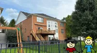 a house with a fence and a cartoon character on it
