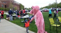 a child giving a high five to panther mascot