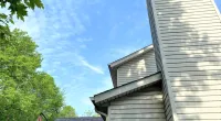 a house with trees in the background