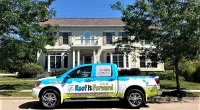 a Roof It Forward truck parked in front of a house