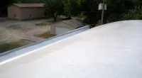a person riding a skateboard up the side of a road